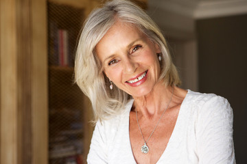 Wall Mural - beautiful older woman standing in study smiling