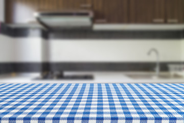 Empty table with tablecloth and blurred kitchen background, product montage display.