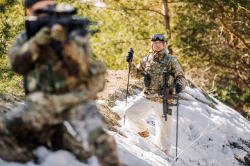 team of special forces weapons in cold forest. Winter warfare and military concept