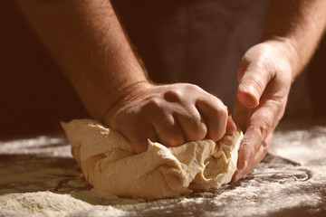 Poster - Man kneading dough in kitchen, closeup