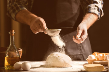 Wall Mural - Man making dough in kitchen