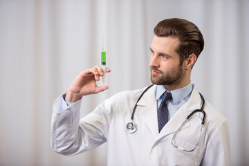 Wall Mural - Doctor holding syringe