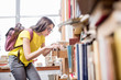 © rh2010 - Young student searching books with card catalogue at the old library or archive