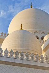 Domes of the mosque against blue skies in Abu Dhabi, UAE