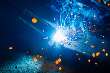 Poster - artistic welding sparks light, industrial background