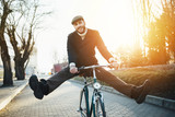 Fototapeta  - Man with bicycle having fun