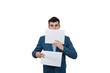 Portrait of a smiling businessman holding two white papers one hiding half face on a white background.
