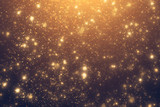 Fototapeta Kosmos - Golden rays and sparkles or glitter lights. Merry Christmas festive background.defocused circle bokeh or particles