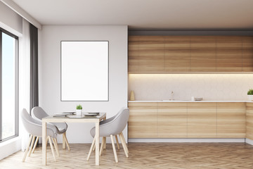 Light wood kitchen with table and poster