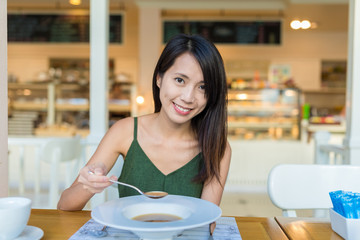 Wall Mural - Woman enjoy soup in restaurant