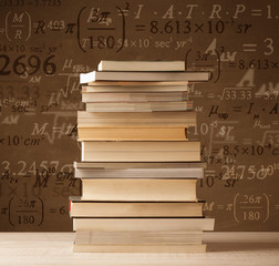 Books on vintage background with math formulas