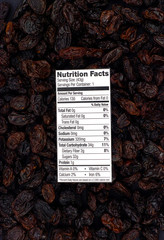 Wall Mural - Nutrition facts of organic raisins with raisins background