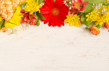 Composition Of  Bright Flowers On A Wooden Table
