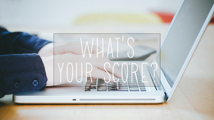 Wall Mural - What is your Score, text over young man typing on laptop at desk