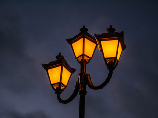 night old-fashioned lantern on the backdrop of a gloomy sky