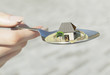 woman hand holding spoon with paper house real estate business concept photo