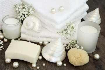 Wall Mural - Body Care Cleansing Products. With white  bathroom accessories, moisturising cream, soap, white flannels, natural sponge, candle, mother of pearl shells and pearls.