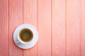 Poster - Coffee cup and beans on a pink wood  background.