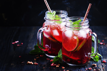 Canvas Print - Tea with hibiscus, fruit, mint and ice, selective focus