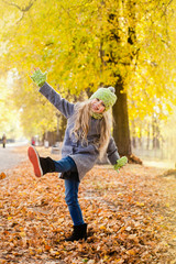 little girl walks in the autumn