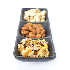 Sticker - Assorted mixed nuts in black plate on white background