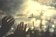 © Creativa Images - Hands praying to the God in the hill