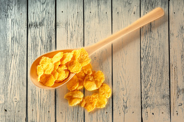 Wall Mural - Wooden spoon with corn flakes