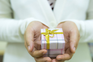 Female hands holding gift box