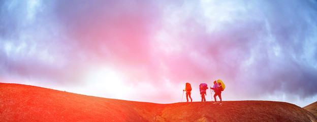 Wall Mural - hikers on the trail in the Islandic mountains. Trek in National Park Landmannalaugar, Iceland