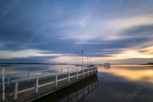 wooden pier by the sea, long exposure, evening Poster