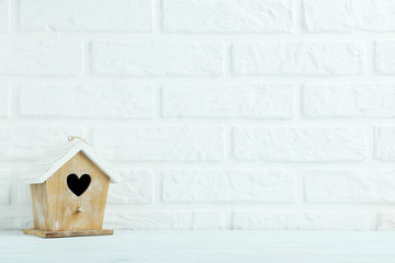 Wall Mural - Wooden nesting box on the brick wall background