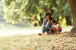 © BalanceFormCreative - Mother holding her daughter and playing around the park on beautiful day.