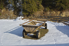 Old Wooden Cart In The Courtyard In Winter In The Snow