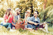 © ivanko80 - Happy young friends having picnic in the park