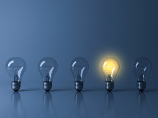 Poster - One yellow glowing light bulb standing out from the unlit incandescent bulbs on dark blue background with reflection and shadow , individuality and different creative idea concepts . 3D rendering.
