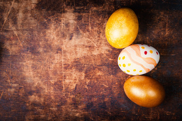 Wall Mural - Easter eggs on wooden background  with copyspace. Happy Easter!.