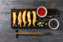 Fried Tempura Shrimps On Lettuce Salad With Sauces. Served In Traditional China Plate With Chopsticks On Wood Serving Board And Textile Napkin Over Old Metal Background. Top View, Space. Asian Dinner