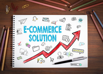 Canvas Print - E-Commerce Solution, Business Concept. Notebooks, pen and colored pencils on a wooden table.