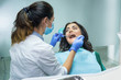 © DenisProduction.com - Woman at the dentist. Stomatologist in mask working. Oral health assessment.