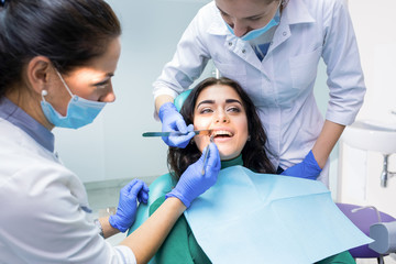 Dental doctors examining patient. Dentists are working.