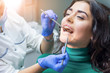 © DenisProduction.com - Hands of dentist at work. Mouth mirror and probe. Dental insurance guide.