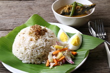 Nasi Dagang, A Popular Malaysian Meal On The East Coast Of The Malaysian Peninsular. It Consists Of Rice Steamed In Coconut Milk, Fish Curry, Hard Boiled Eggs And Pickled Vegetables.