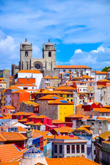 View over the old town of Porto, Portugal with the cathedral, colorful buildings and orange roofs