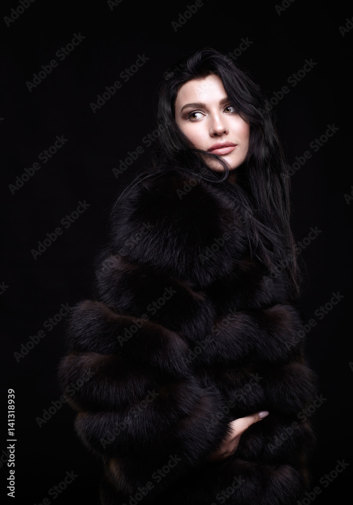 Portrait of a young brunette woman with long black hair dressed in a ...