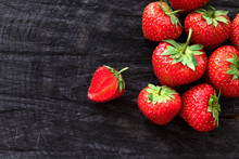 Red Fresh Strawberries On Black Rustic Wood Background