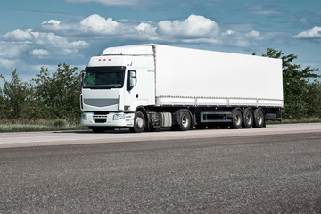 Wall Mural - Truck on road, blue sky, cargo transportation concept