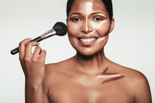 Beautiful Young Woman Applying Makeup