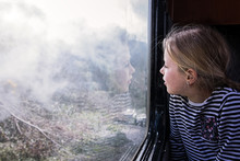 Girl On Train Looking Out Of Window