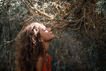 Wall Mural - sensitive portrait of beautiful young woman in forest