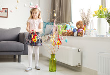 Girl Making Easter Decorations In Living Room